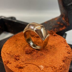 Casted bronze ring on the sand used for sand casting